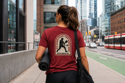 Person wearing a red t-shirt with a logo, walking on a city street. pickleball gift.