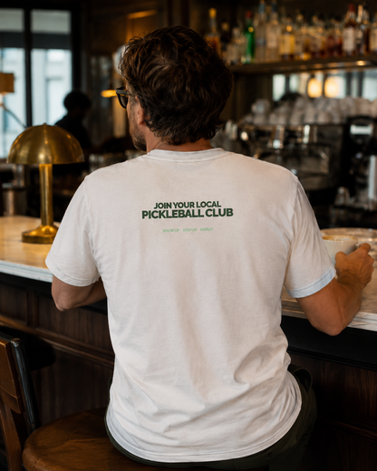 Man wearing pickleball club shirt at café