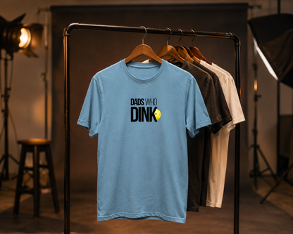 Dads Who Dink pickleball shirt on clothing rack in moody studio
