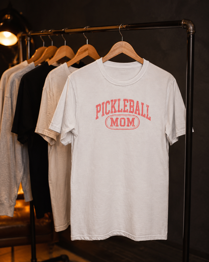 Pickleball Mom shirt on clothing rack in moody studio